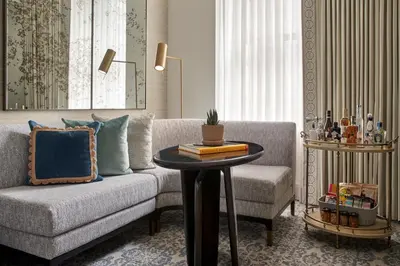 a living room with a couch and a table at The Wall Street Hotel New York City in New York