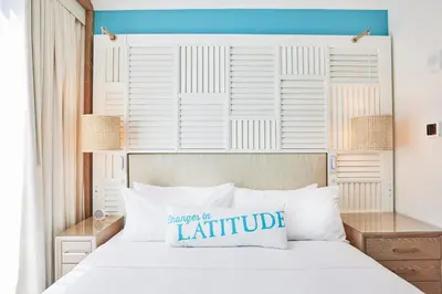 a bedroom with a white bed with a white headboard at Margaritaville Resort Times Square in New York