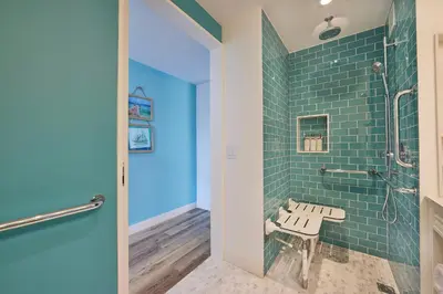 a bathroom with a bench next to a shower at Margaritaville Resort Times Square in New York