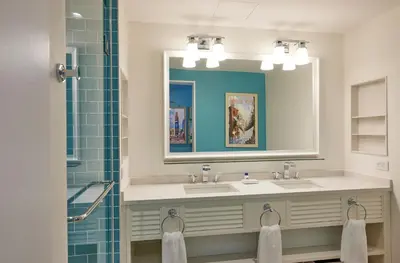 a bathroom with two sinks and a mirror and a shower at Margaritaville Resort Times Square in New York