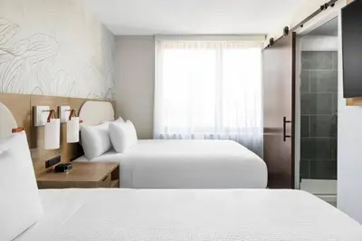 a hotel room with two beds and a window at SpringHill Suites by Marriott New York Manhattan Chelsea in New York