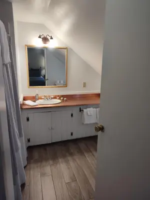 a bathroom with a sink and a mirror at Doveberry Inn in West Dover