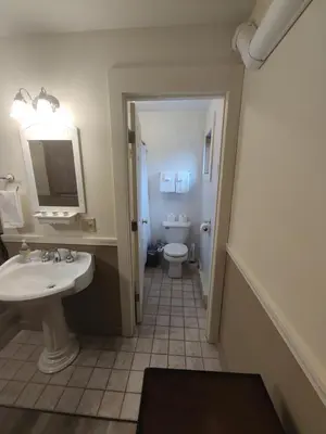 a bathroom with a sink and a toilet at Doveberry Inn in West Dover