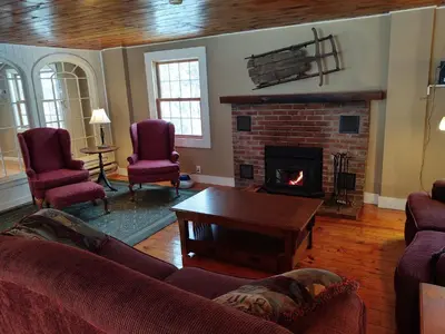 a living room with a couch and a fireplace at Doveberry Inn in West Dover