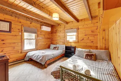 a bedroom with two beds in a log cabin at Hike and Ski Log Cabin in East Stroudsburg! in East Stroudsburg