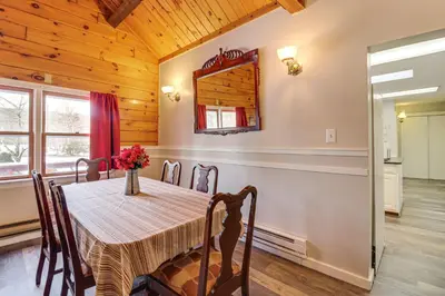 a dining room with a table and a mirror at Hike and Ski Log Cabin in East Stroudsburg! in East Stroudsburg