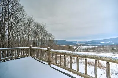 a wooden fence covered in snow next to a fence at Full Private Home on 32-Acres with Stellar Views! in North Blenheim