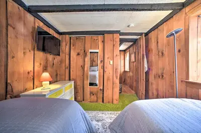 a bedroom with wood paneled walls and a bed at Cozy Great Barrington Home about 1 Mi to Ski Resort! in Great Barrington