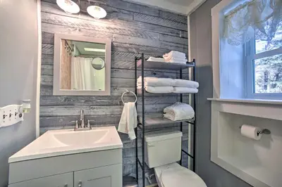 a bathroom with a sink and a toilet and a mirror at Cozy Great Barrington Home about 1 Mi to Ski Resort! in Great Barrington