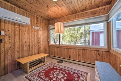 a room with wooden walls and a table and a window at Cozy Great Barrington Home about 1 Mi to Ski Resort! in Great Barrington