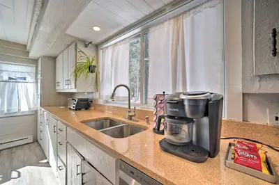 a kitchen with a sink and a coffee maker on a counter at Cozy Great Barrington Home about 1 Mi to Ski Resort! in Great Barrington