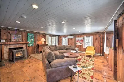 a living room with a couch and a fireplace at Cozy Great Barrington Home about 1 Mi to Ski Resort! in Great Barrington