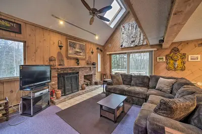 a living room with a couch and a fireplace at Cozy Mountain Retreat with Deck about 3 Mi to Mount Snow in West Dover