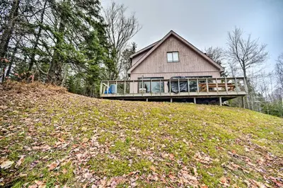 a house on top of a grassy hill at Cozy Mountain Retreat with Deck about 3 Mi to Mount Snow in West Dover