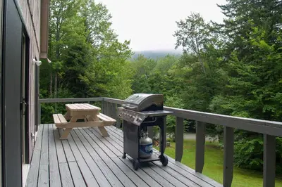 a grill on a deck with a picnic table on a porch at Cozy Mountain Retreat with Deck about 3 Mi to Mount Snow in West Dover