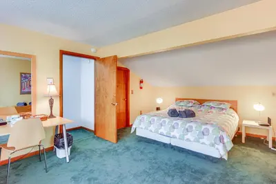 a hotel room with a bed and a desk and a desk at Primely Located Dover Escape Less Than 1 Mi to Mt Snow! in Dover