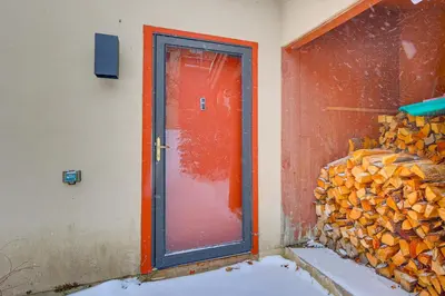 a door to a room with a pile of wood at Primely Located Dover Escape Less Than 1 Mi to Mt Snow! in Dover