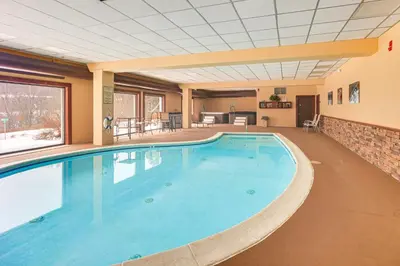 a large pool with blue water in a building at Primely Located Dover Escape Less Than 1 Mi to Mt Snow! in Dover