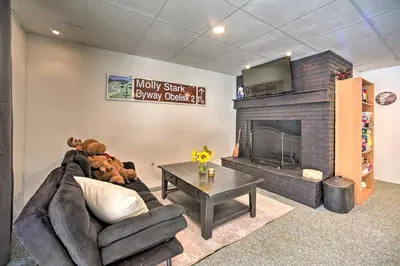 a living room with a couch and a fireplace at Cozy A-Frame Cabin with Pool Table 8 Mi to Mt Snow! in Wilmington