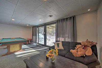 a living room with a couch and a pool table at Cozy A-Frame Cabin with Pool Table 8 Mi to Mt Snow! in Wilmington