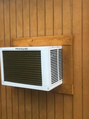 a air conditioner hanging on a wall at The HideAway Tiny Cabin in East Durham