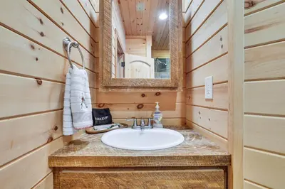 a bathroom with a sink and a mirror at Quiet Snow Estate Retreat in the Poconos in Nay Aug