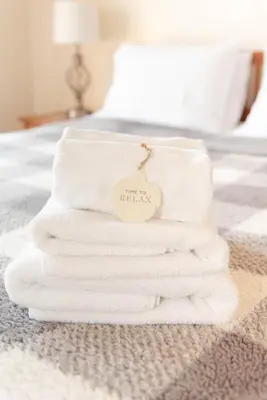 a stack of white towels sitting on a bed at Camelback Private Home located behind Waterpark & Ski Lift in Tannersville