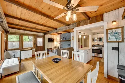 a dining room and kitchen with a wooden ceiling at Lakefront Granby Escape with Private Dock and Kayaks! in Granby