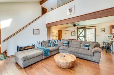 a living room with a couch and a table at Fire Pit and Gas Grill Charming Poconos Abode! in Bushkill