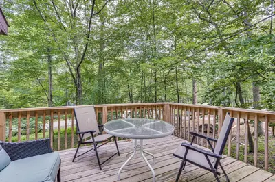 a patio with a table and chairs on a deck at Screened Porch and Deck Pet-Friendly Poconos Escape in Lackawaxen