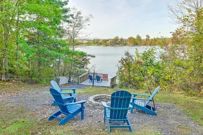 a group of blue chairs sitting next to a fire pit at Hot Tub Secluded Hideaway on Sleepy Hollow Lake in Athens