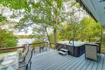 a deck with a hot tub and a table and chairs at Hot Tub Secluded Hideaway on Sleepy Hollow Lake in Athens