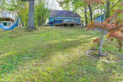 a yard with a swing and a house at Hot Tub Secluded Hideaway on Sleepy Hollow Lake in Athens