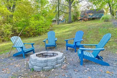 three blue chairs sitting around a fire pit at Hot Tub Secluded Hideaway on Sleepy Hollow Lake in Athens