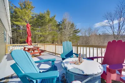 a group of chairs and a table on a deck at Private 7-Acre Retreat On-Site Pond, Streams in Jewett