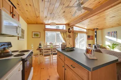a kitchen with wooden ceilings and a wooden floor at Private 7-Acre Retreat On-Site Pond, Streams in Jewett