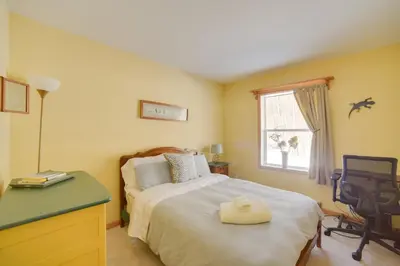 a bedroom with a bed and a desk and a window at Private 7-Acre Retreat On-Site Pond, Streams in Jewett