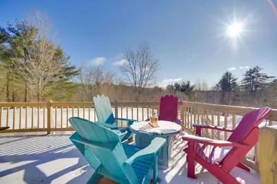 a group of chairs and a table on a deck at Private 7-Acre Retreat On-Site Pond, Streams in Jewett