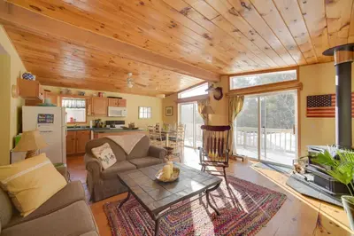 a living room with a couch and a table at Private 7-Acre Retreat On-Site Pond, Streams in Jewett
