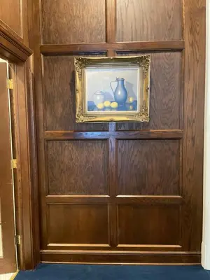 a wooden door with a picture on the wall at The Argus Hotel & Cocktail Lounge in Albany