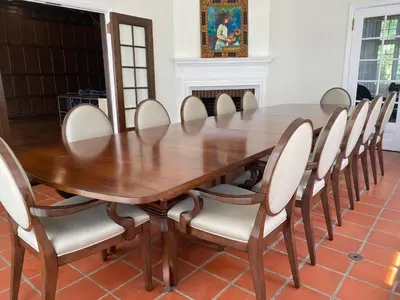 a wooden table with chairs around it in a room at The Argus Hotel & Cocktail Lounge in Albany
