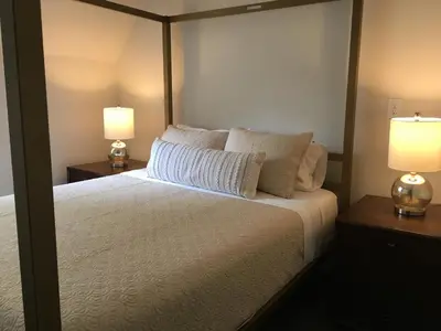 a bedroom with a bed with two lamps on tables at The Argus Hotel & Cocktail Lounge in Albany