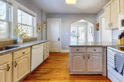 a large kitchen with wooden cabinets and a counter top at Belltown Retreat in Stamford