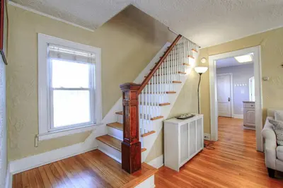 a living room with a staircase and a window at Belltown Retreat in Stamford