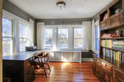 a room with a desk with chairs and windows at Belltown Retreat in Stamford