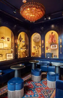 a bar with blue seats and a chandelier at CIVILIAN Hotel in New York