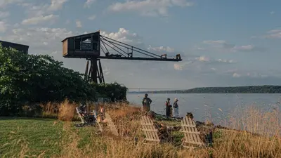 people standing on the shore of a body of water at Hutton Brickyards Riverfront Hotel & Venue in Kingston