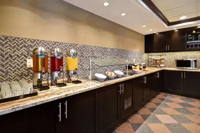 a kitchen with a counter with aasteryasteryasteryasteryasteryasteryasteryasteryastery at Homewood Suites by Hilton Hartford / Southington CT in Southington