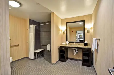 a bathroom with a sink and a shower and a mirror at Homewood Suites by Hilton Hartford / Southington CT in Southington