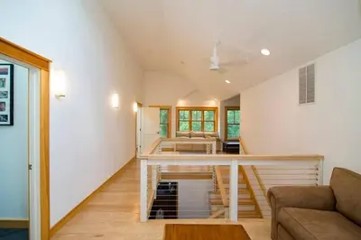 a living room with a table and a couch at Too Good AKA 2 Goodrich St in Stockbridge